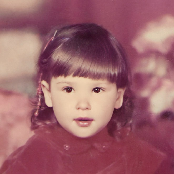 Vintage-style portrait of a young girl with a blurred background
